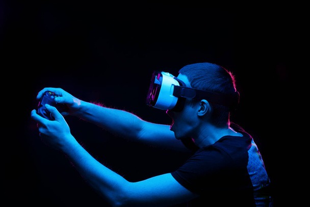 Man with virtual reality headset is playing game. - Foto, Bild