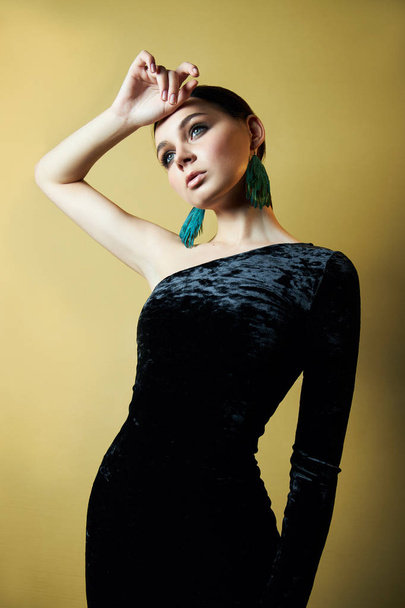 Brunette girl dressed in a chic black evening dress with an open - Foto, Imagem