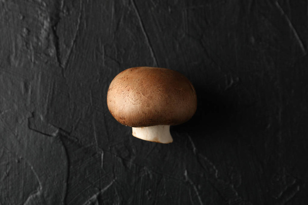 Raw champignon mushroom on black background, close up - Φωτογραφία, εικόνα