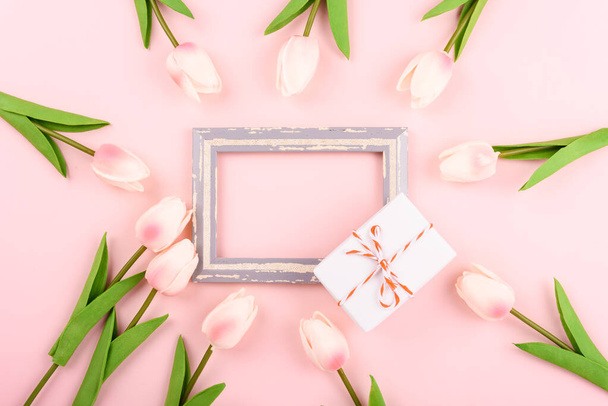 Happy Women's Day, Mother's Day concept. top view flat lay photo frame, gift box and Tulip flower on pink background, copy space for your text - Fotoğraf, Görsel