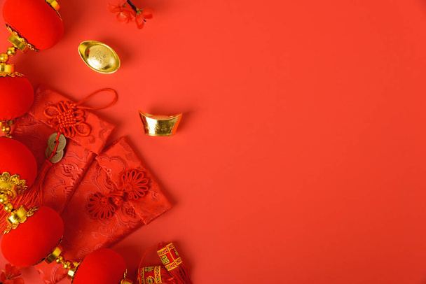 Chinese new year festival concept, flat lay top view, Happy Chinese new year with Red envelope and gold ingot on red background with copy space for your text - Foto, afbeelding