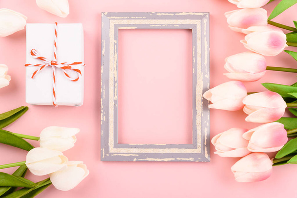 Happy Women's Day, Mother's Day concept. top view flat lay photo frame, gift box and Tulip flower on pink background, copy space for your text - Foto, imagen