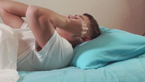 Young man close-up can not sleep, from a headache. insomnia bad sleep, cant sleep - Metraje, vídeo