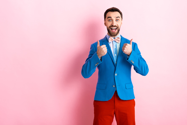 cheerful bearded businessman showing thumbs up on pink  - Photo, Image
