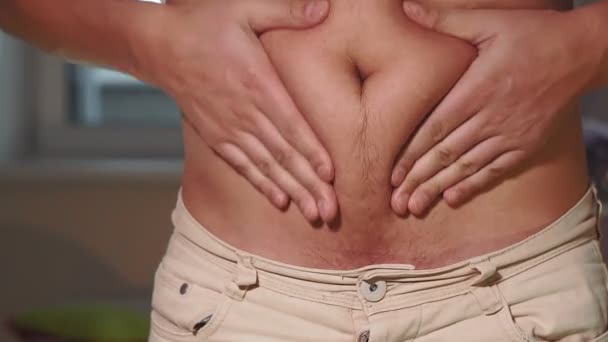 young caucasian man grabbing the fat of his hairy stomach. belly fat, weight loss, overweight - Footage, Video