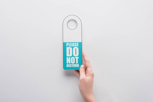 cropped view of woman holding please do no disturb sign on white background - 写真・画像