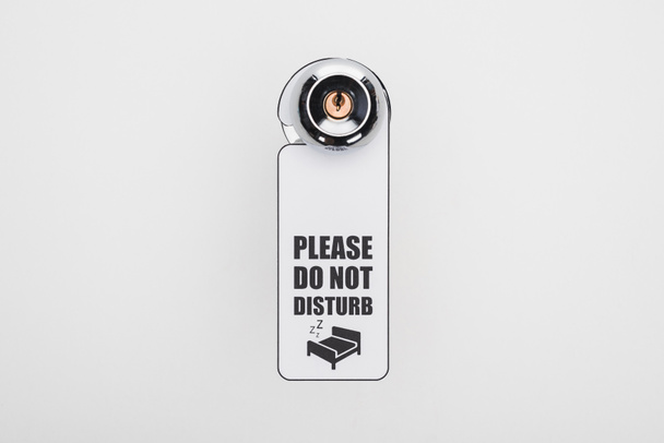 please do no disturb sign on handle with lock on white background - Foto, Bild