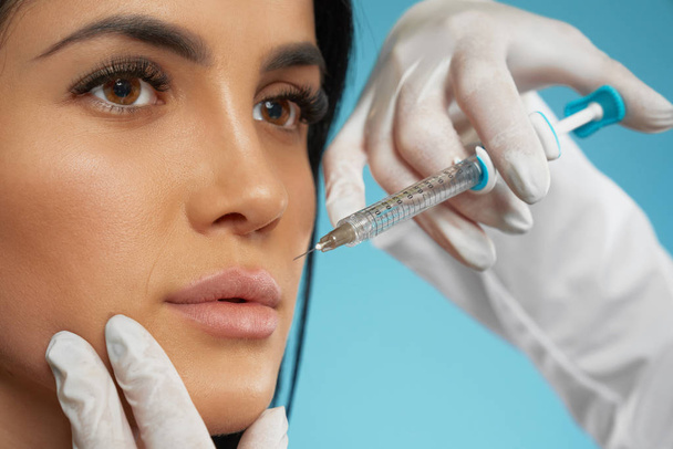 Cosmetic hyaluronic injection in lips. - Foto, afbeelding