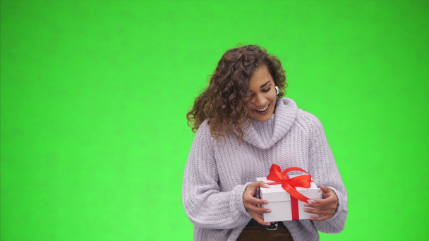 Afro-American woman is catching a giftbox with red ribbon. Best wishes. Close up. Copy space. - Filmagem, Vídeo