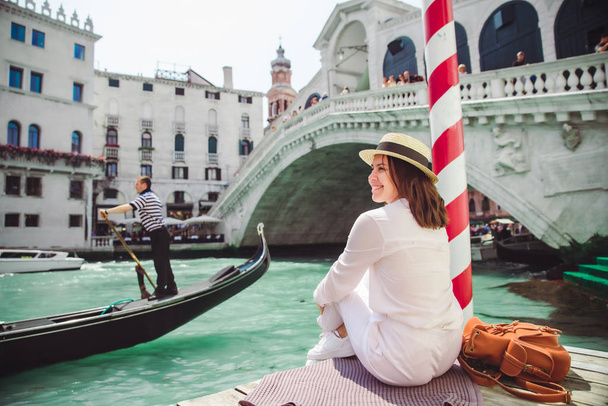kobieta siedzi w pobliżu mostu Rialto w Wenecji Włochy patrząc na Grand Canal z gondoli - Zdjęcie, obraz
