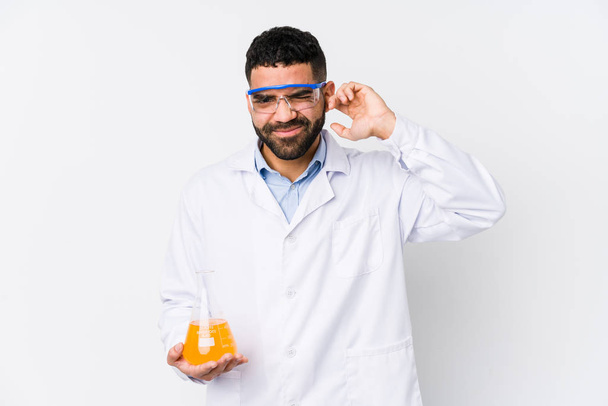 Young arabian chemical man isolated covering ears with hands. - Photo, Image