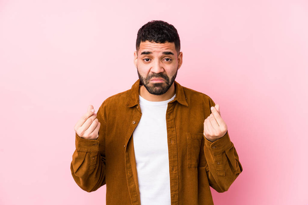 Young latin man against a pink background isolated showing that she has no money. - Фото, изображение
