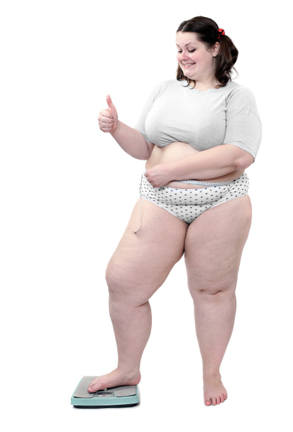 Mujer feliz con sobrepeso medir su cintura vientre por metro-palo en una máquina de pesaje
. - Foto, Imagen