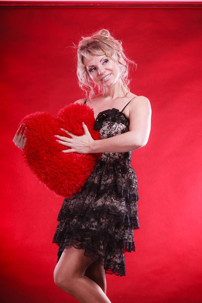 Woman holds big red heart love symbol - Foto, Imagem
