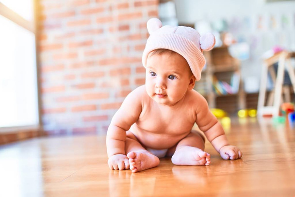 Adorable baby lying down on the sofa at home. Newborn wearing fanny hat relaxing and resting comfortable - Photo, Image