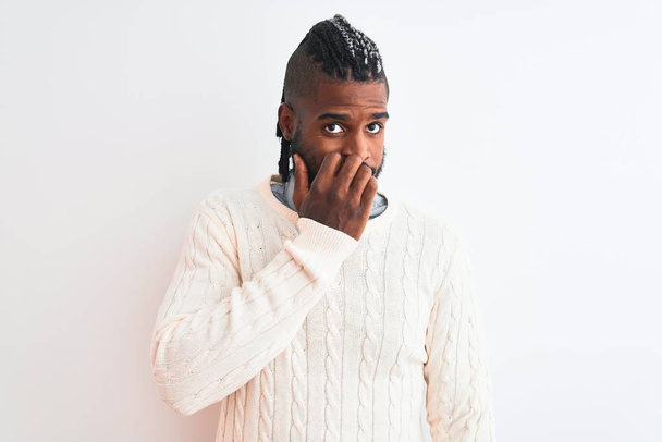 African american man with braids wearing white sweater over isolated white background looking stressed and nervous with hands on mouth biting nails. Anxiety problem. - Photo, Image