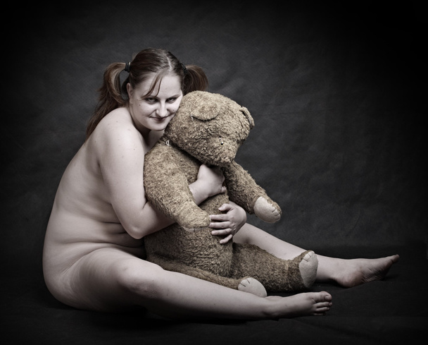 Studio shot overweight woman with old Teddy bear. Great for calendar. - Photo, Image