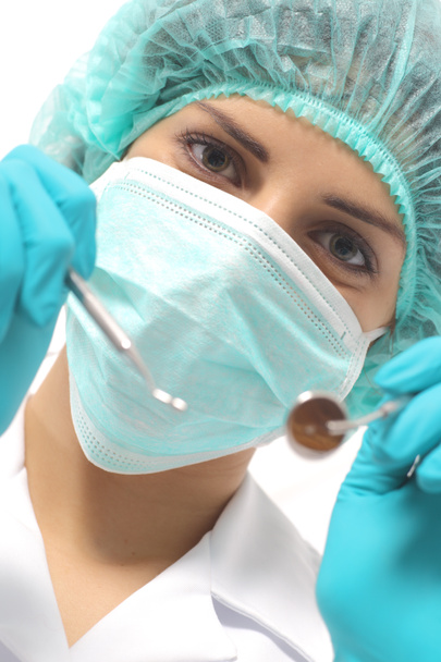 Close up of a dentist woman with a mask holding tools ready to operate - Foto, afbeelding
