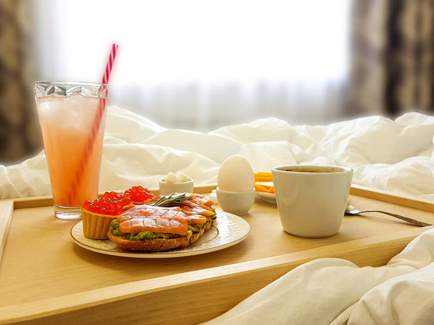 Healthy breakfast in bed for a girl in a cozy bedroom. - Fotoğraf, Görsel