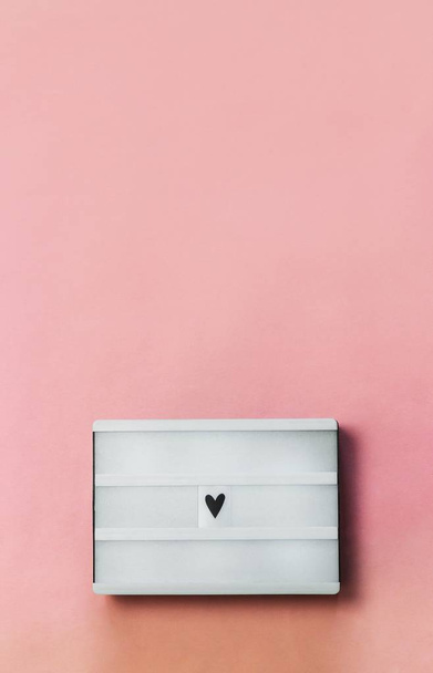 Világos doboz szív jel rózsaszín háttér. Szerelem, Szent Valentin napi háttér vagy üdvözlőlap. Felülnézet, másolás, lágy fókusz. - Fotó, kép