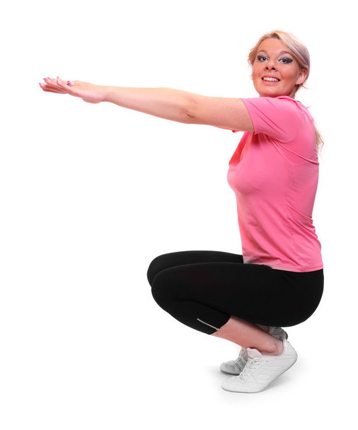 Shot of a sporty young woman stretching on a white background. - Valokuva, kuva