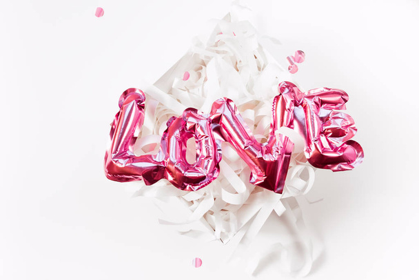 Love concept. Inflatable pink balloon with letters - Fotó, kép