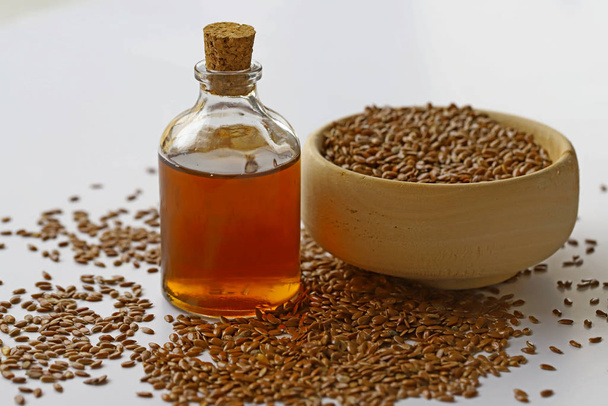 Sesame seeds in bowl and sesame oil in bottle - Photo, Image