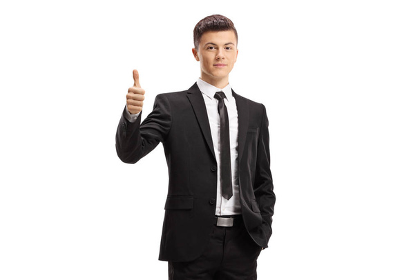 Young man wearing elegant suit and giving thumbs up - Fotó, kép