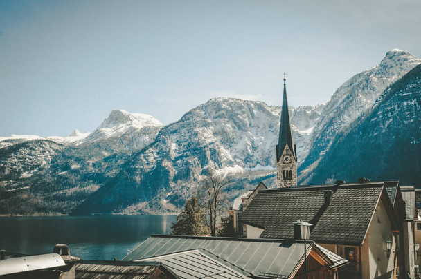 Spectacular view on the cathedral in Hallstatt with high mountai - Photo, Image