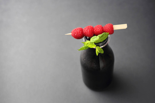 Black lemonade, a healthy drink with activated carbon with raspberries and myth. - Photo, Image