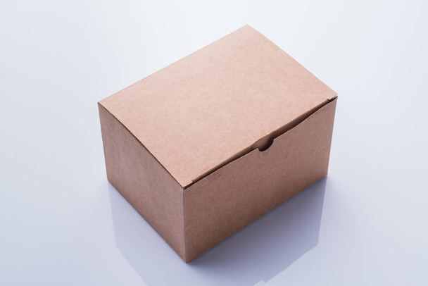 Closed plain cardboard box. - Fotó, kép
