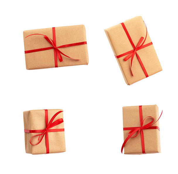 caja rectangular envuelta en papel marrón y atada con un lazo rojo
 - Foto, Imagen