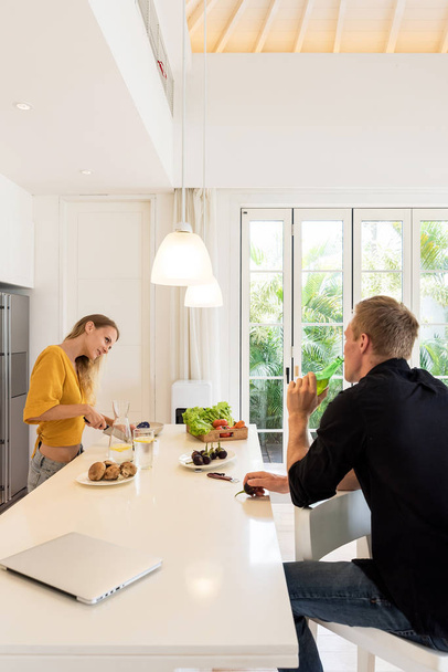 Paar macht Mittagessen auf einer weißen Inselküche zu Hause - Foto, Bild