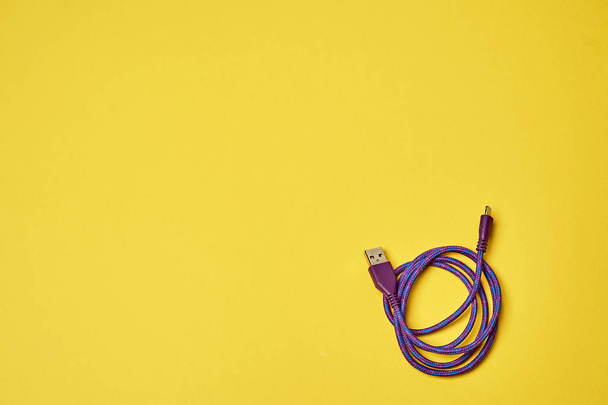 Electric charging for devices.Electronics. Minimalism. Yellow - Foto, Imagen