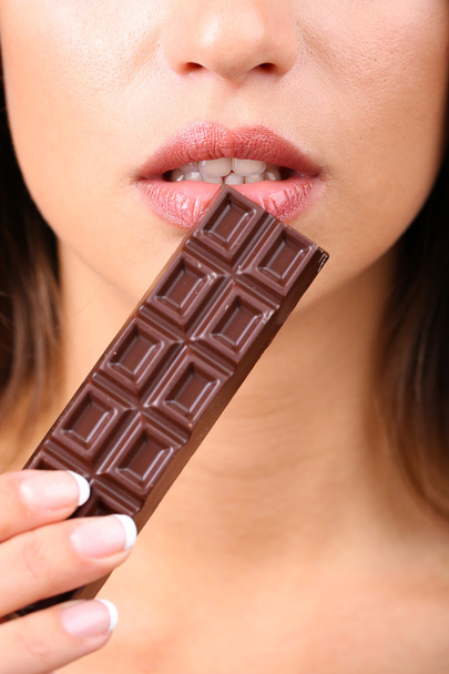 Closeup of woman eating chocolate - Foto, Imagem