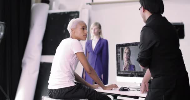 Photographer and client reviewing shots on a fashion shoot - Footage, Video