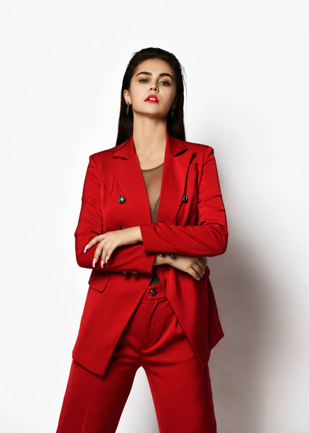 Young fashionable beautiful sexy business woman in expensive designer stylish red office suit on a white background - Zdjęcie, obraz