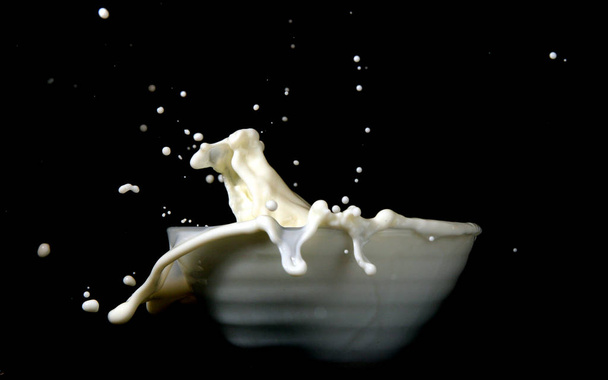 milk splash isolated on black background - Fotó, kép