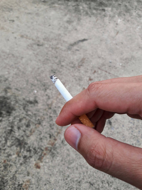 Colheita de cigarro à mão com fundo de concreto. - Foto, Imagem