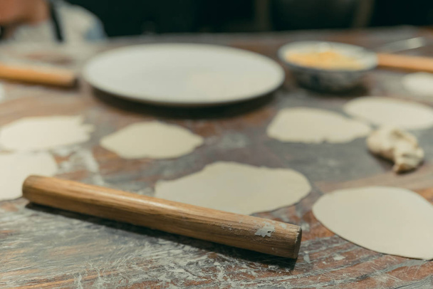 Wooden rolling pin for flattening dough for dumplings - Photo, Image