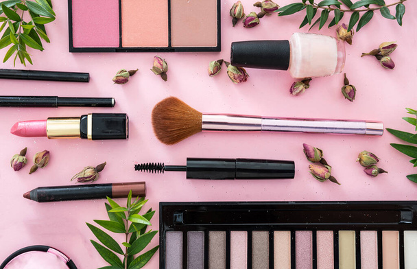 Maquillaje de productos cosméticos contra el fondo de color rosa
 - Foto, imagen