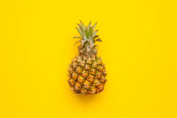 Tropical fruit pineapple on yellow background with copyspace - Foto, Imagem
