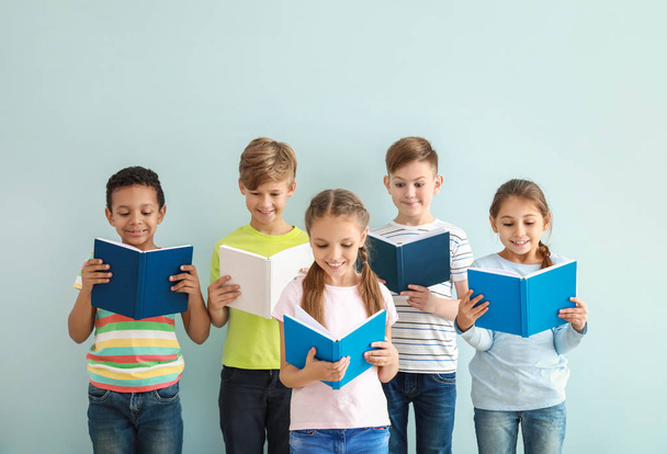 Cute little children reading books on color background - Foto, imagen