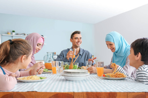 Muslim family having dinner at home - Фото, изображение