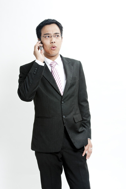 Businessman talking on cellphone - Foto, imagen