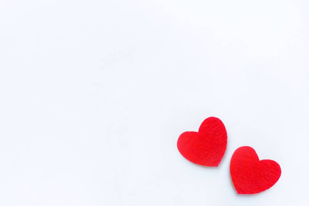Two red felt hearts on a white background. Valentine's day symbol, holiday concept. Top view with copy space for text. - Fotografie, Obrázek
