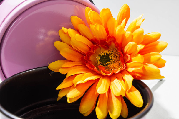 material flower of a chrysanthemum on a children's baking dish - Photo, Image