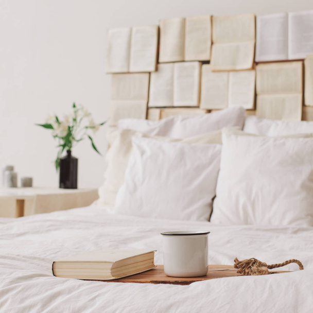 Spring still life. Breakfast in bed. White bedroom. Sweet home. Books and coffee cup. flat lay - Photo, Image