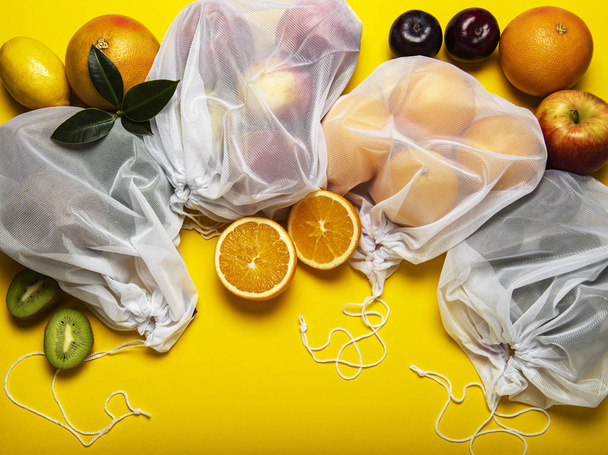 Eco shopping bags with fruits - 写真・画像