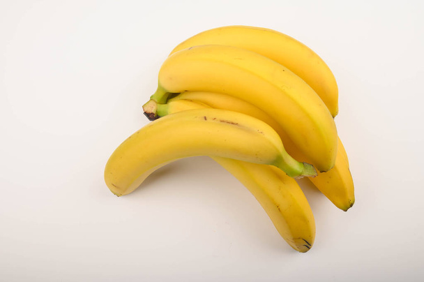 Bunch of ripe yellow bananas on a white background. Close up. - Foto, afbeelding
